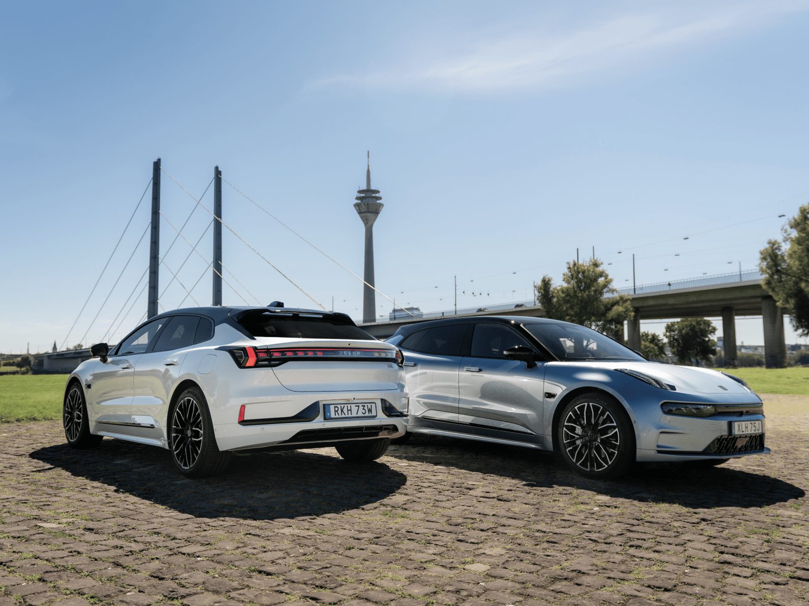 Two ZEEKR 001s in front of a bridge